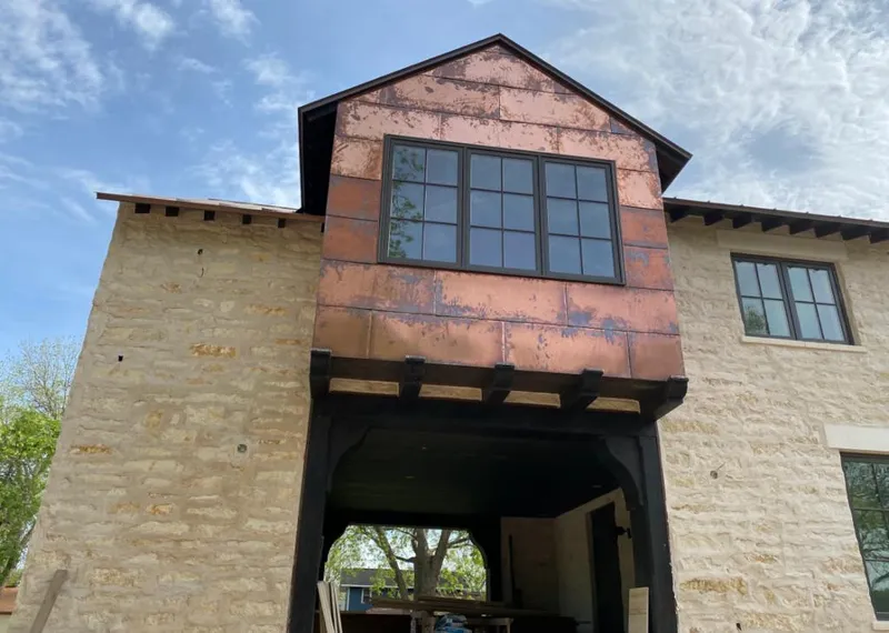 Copper metal panel facade on a stone building for Roof Repair in Queen Creek