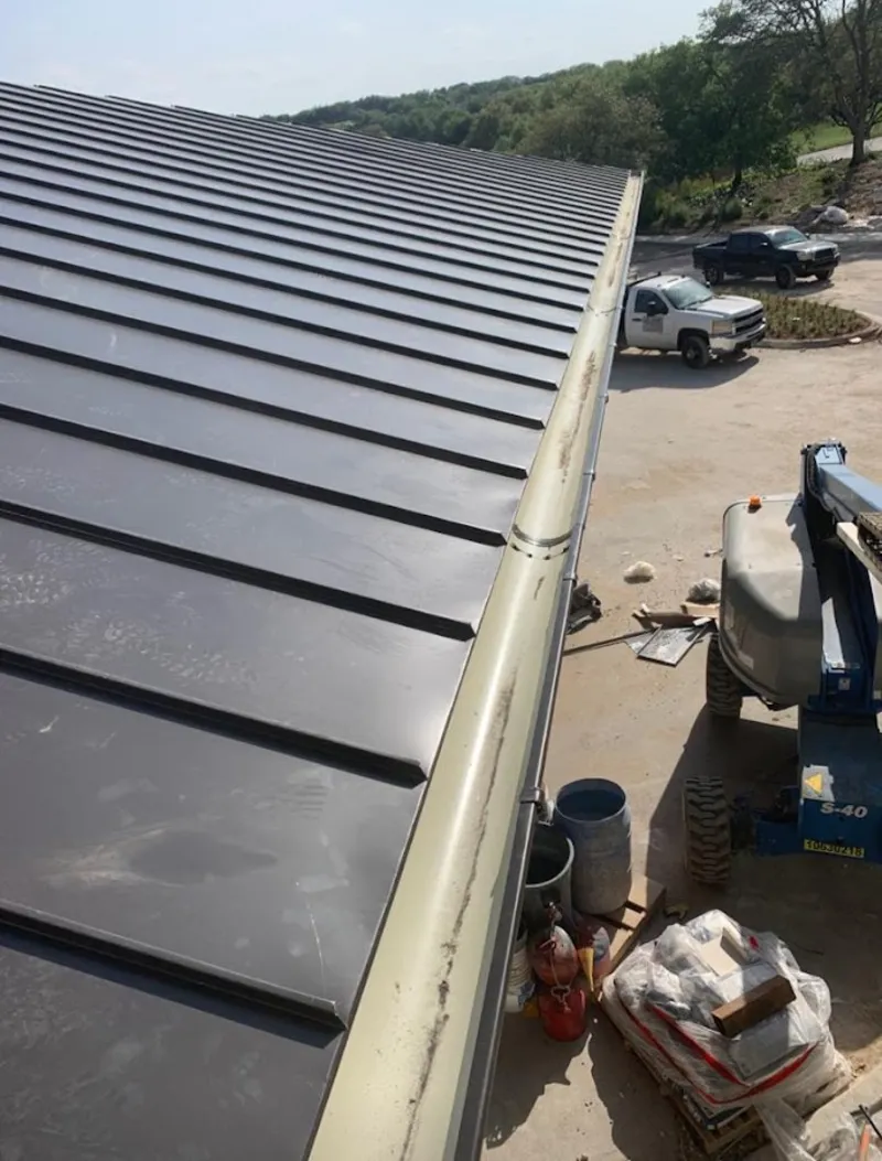 Standing seam panel and gutter detail on a metal roofing jobsite in Queen Creek